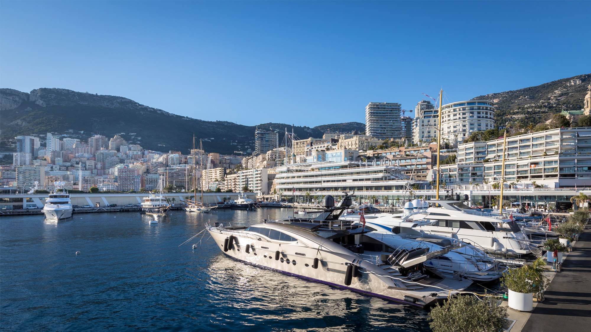 Side view of yachts and Monaco real estate in Port Hercule, Monaco